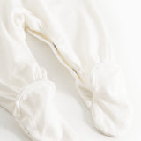 Sheath dress in light cream with ruffled cuffs at the feet