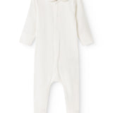 Cream-colored dress with long sleeves and legs with feet, plus a bacon edge at the neckline.