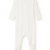 Baby romper in white fabric with a crotch opening and long pants legs.
