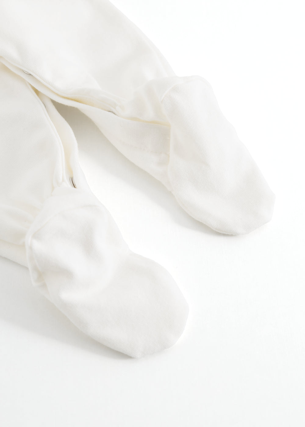 Baby ones with white closed feet and loose fall in the legs