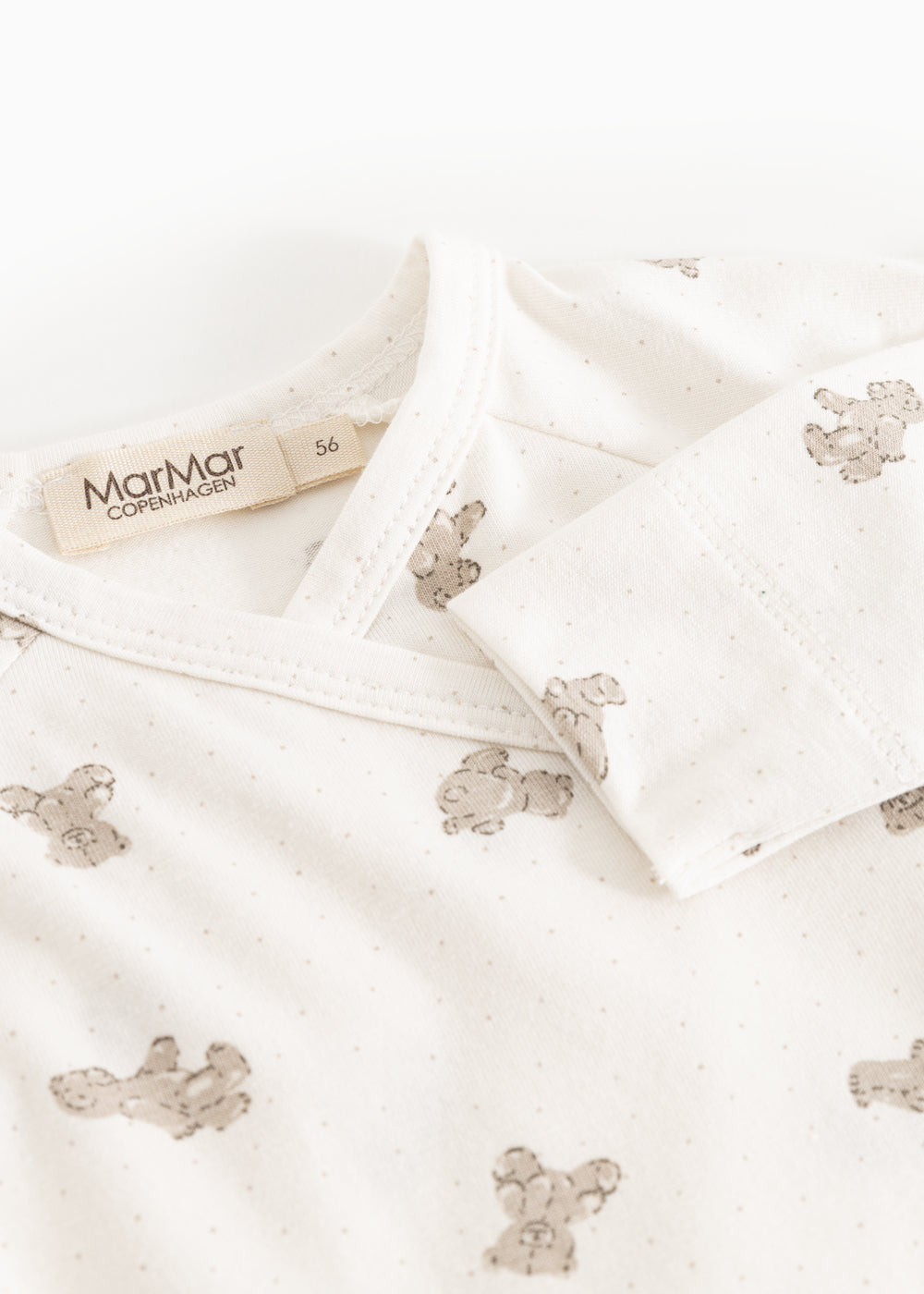 White bodystocking with teddy bear print and MarMar brand at the neckline.