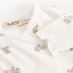 White bodystocking with teddy bear print and MarMar brand at the neckline.