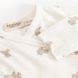 White bodystocking with teddy bear print and MarMar brand at the neckline.