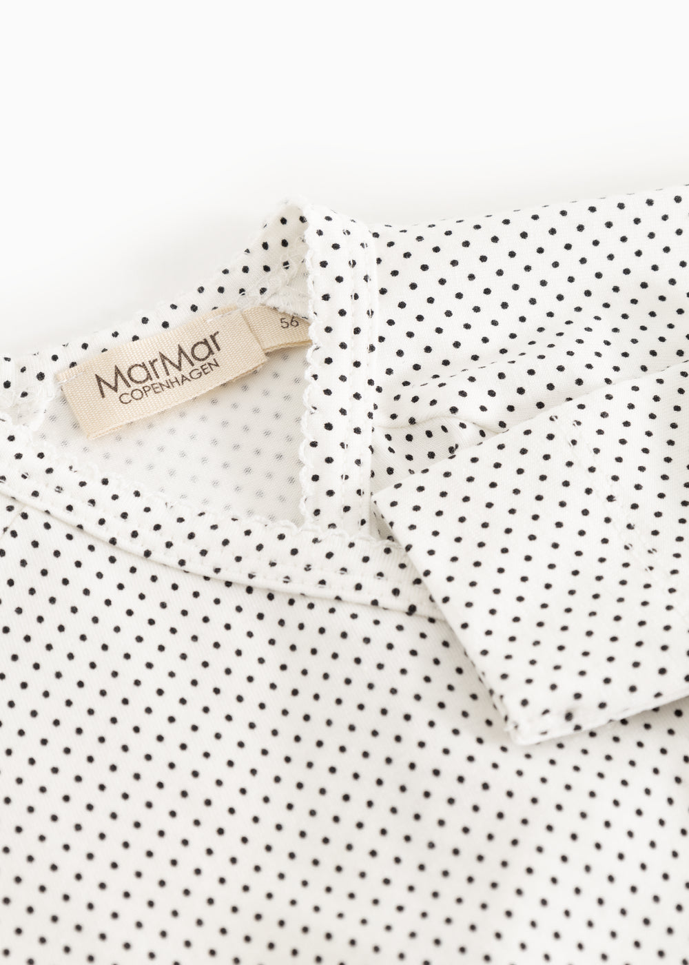 Details: white bodystocking with small black dots and a label at the neck.