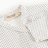 Details: white bodystocking with small black dots and a label at the neck.