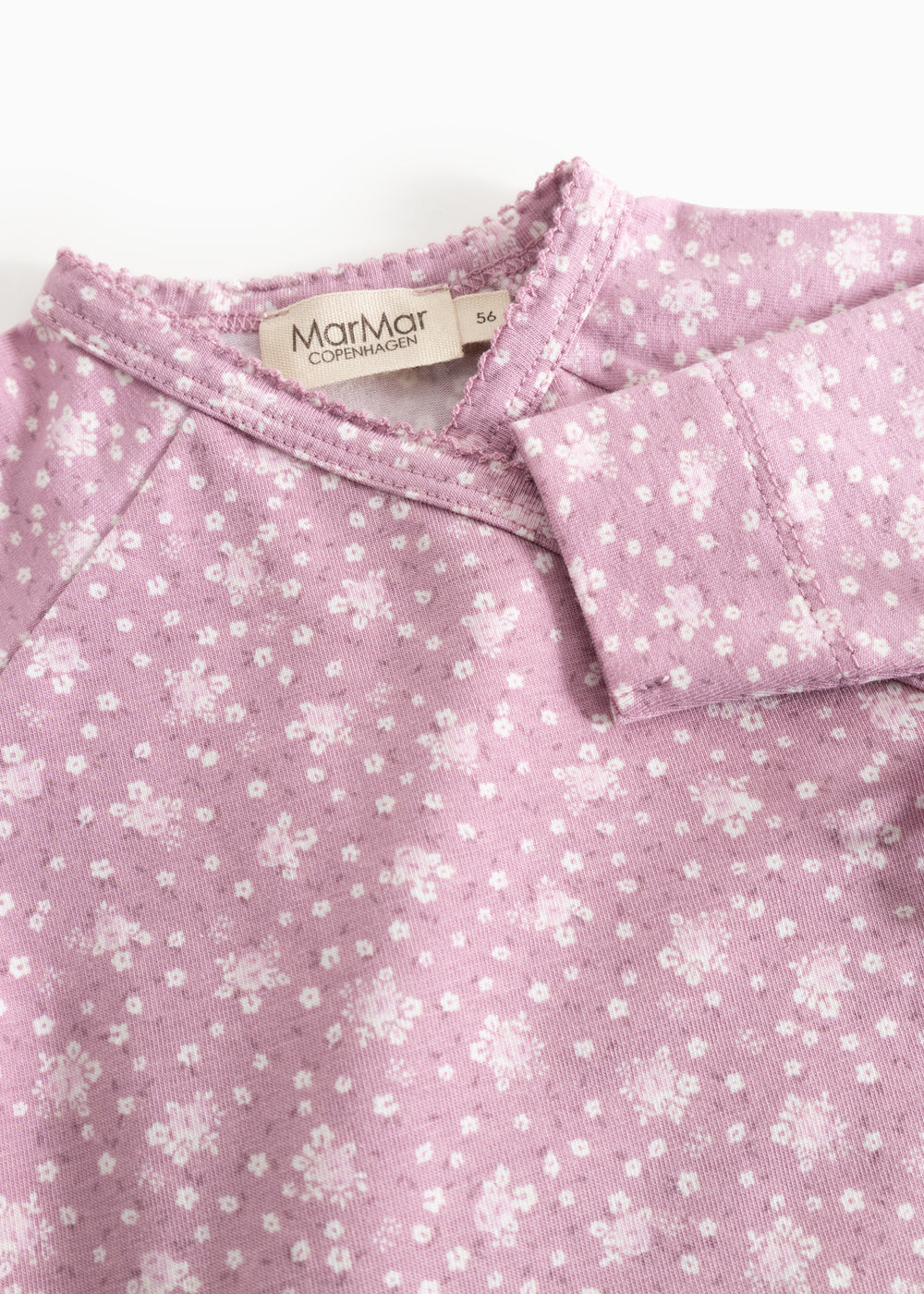 Pink wrap blouse with floral print and MarMar Copenhagen branding at the collar