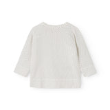 White blouse for baby with small black dots and long sleeves