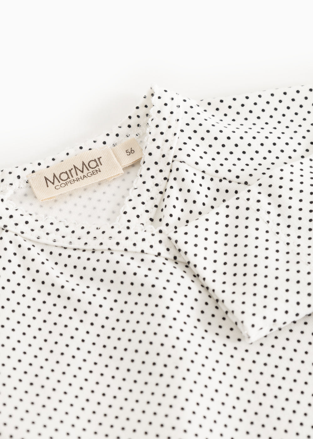 Should detail with buttons on a white blouse with small black dots and MarMar label