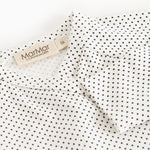 Should detail with buttons on a white blouse with small black dots and MarMar label