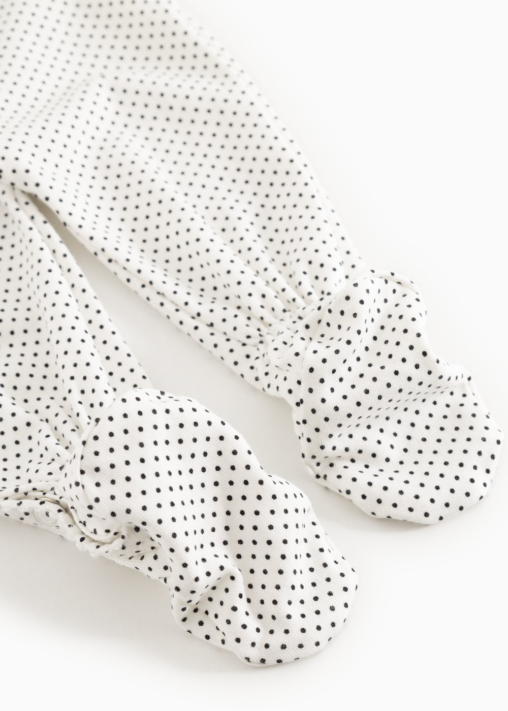 White dress with small black dots, long legs with patterned feet