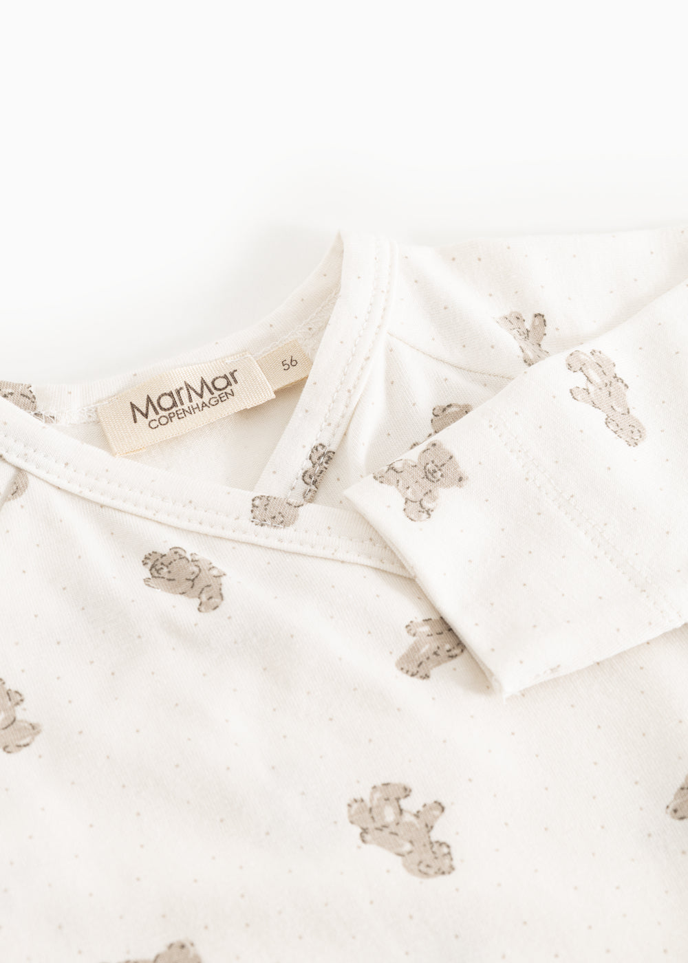White dress with teddy pattern and button closure at the neck