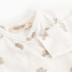 White dress with teddy pattern and button closure at the neck