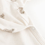 White dress with teddy pattern and snap buttons on the legs