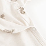 White dress with teddy pattern and snap buttons on the legs