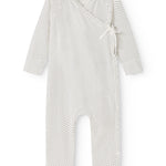 White dress with small black dots, long sleeves and front button closure.