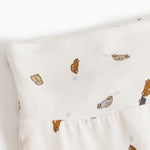 White baby pants with car pattern and soft elastic at the waist.
