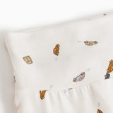 White baby pants with car pattern and soft elastic at the waist.