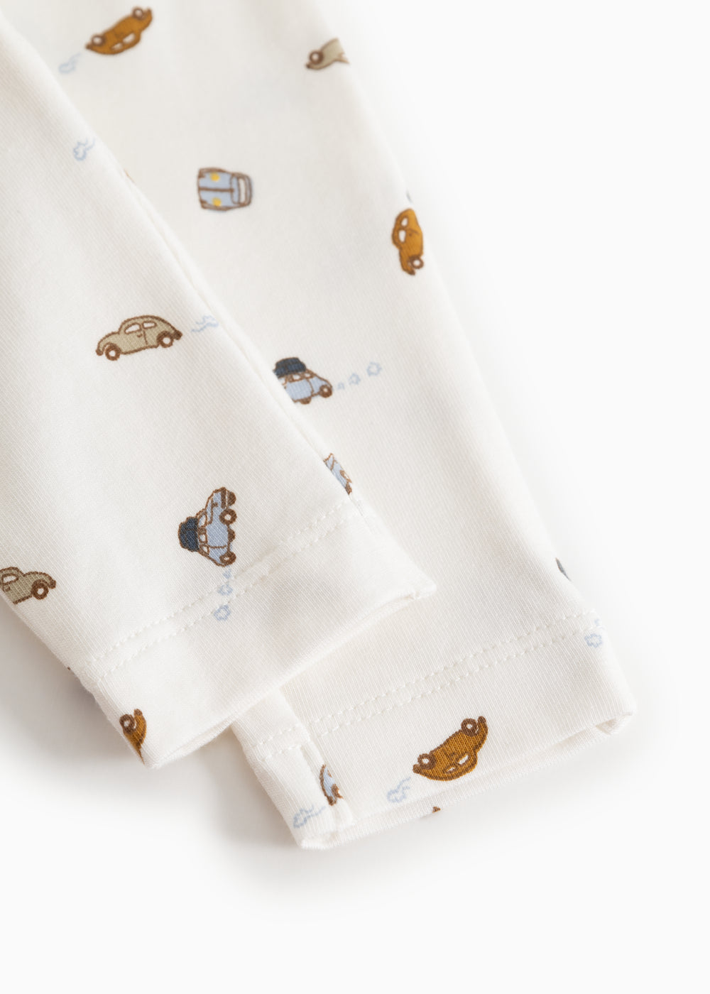 White baby shorts with all-over car print and elastic at the waist.