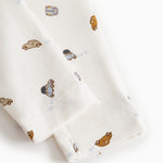 White baby shorts with all-over car print and elastic at the waist.