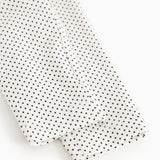 Baby pants with small black dots, close-up of leg ending.