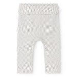 Baby shorts in a light color with small black dots and an elastic waistband.
