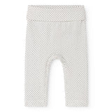 Baby shorts in a light color with small black dots and an elastic waistband.
