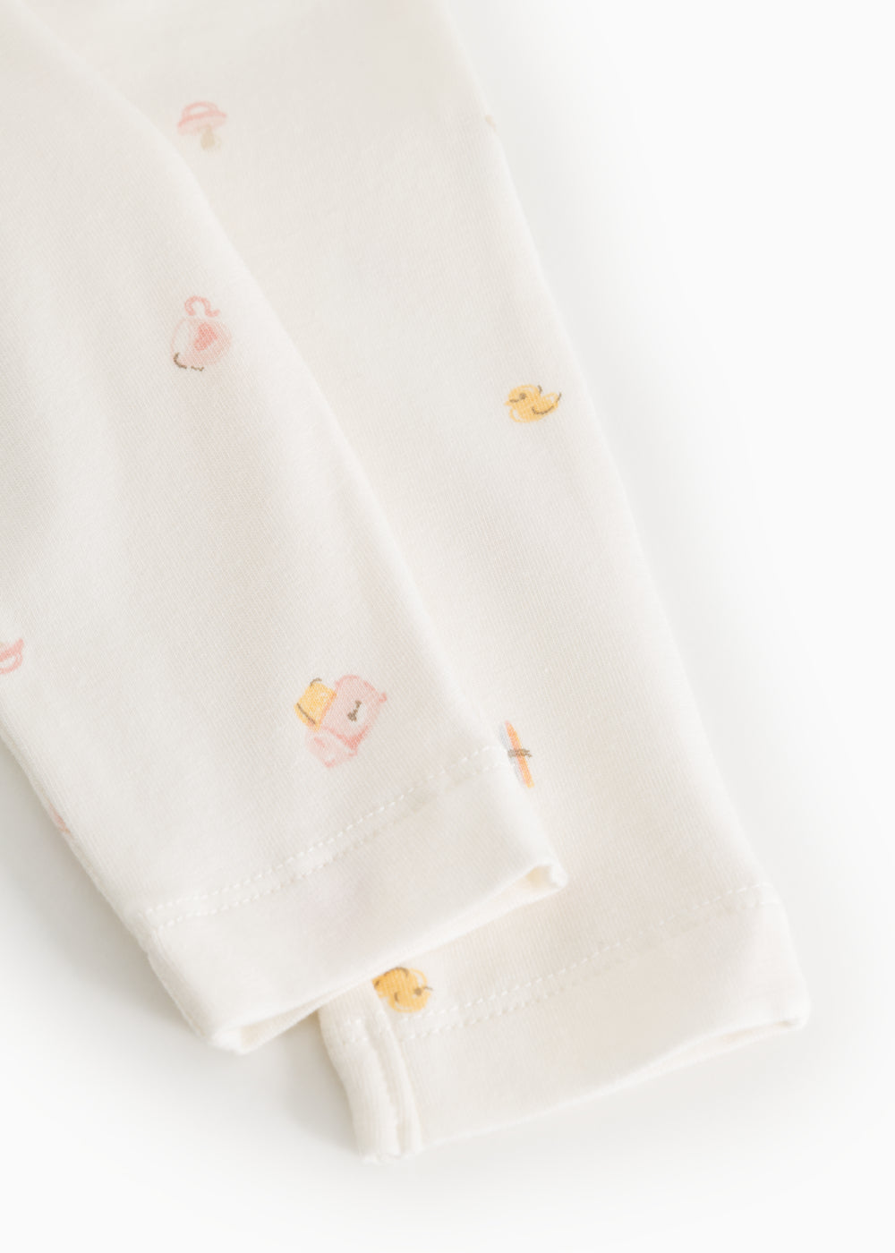 Piva baby pants, close-up of leg opening and seam with pastel animal print