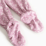 Pink trousers with small white flower print and cuffs at the ankles.
