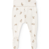 Baby leggings with beige teddy bear print and elastic at the leg opening.