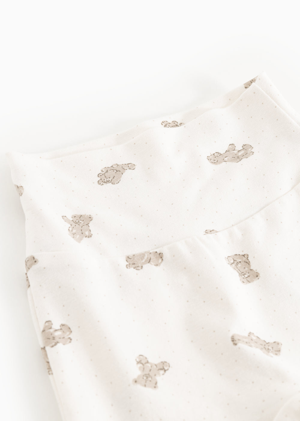 Details of baby pants with repeated teddy bear print