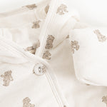 Christmas jacket in cream with a ribbed hem, teddy bear print, and front button closure.