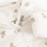 Christmas jacket in cream with a ribbed hem, teddy bear print, and front button closure.