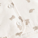 Hooded winter jacket, cream side with teddy bear print and snap buttons.