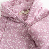 Pink jumpsuit with hood, snap closure and small white flower print.