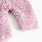 Pink jumpsuit with small white flower print, long legs and sleeves