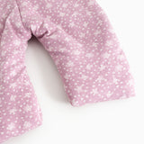 Pink jumpsuit with small white flower print, long legs and sleeves