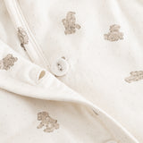 White dress with beige teddy bear pattern and snap buttons at the opening