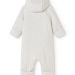White dress with small black dots, hood at the back and long pant legs.