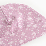 Pink baby onesie cap/hat with small white flowers and a sweet detail at the top