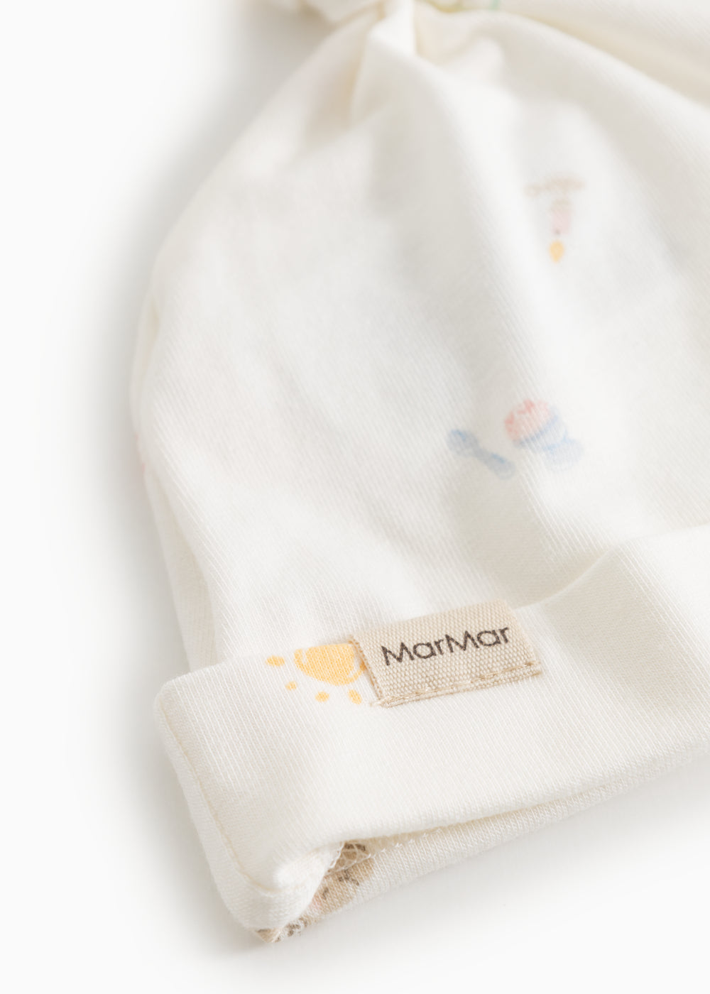 White baby hoodie with knot and elastic edge, featuring the MatMar brand label on the strap.