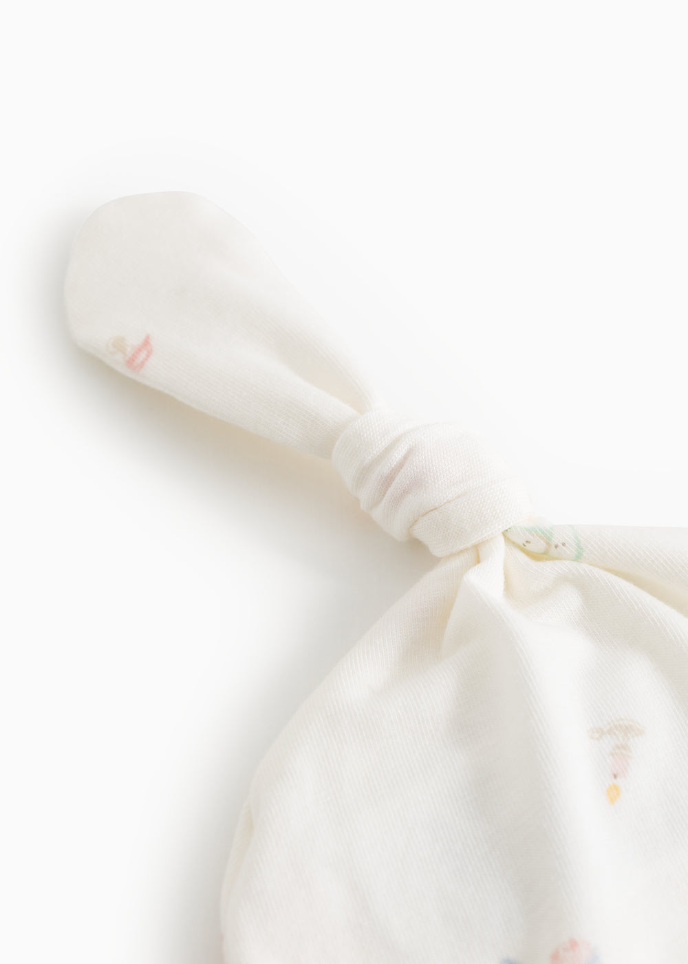 White baby hue with knot and fine rib edge, detail of fabric and patterns.