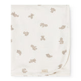 Offwhite rug with teddy bear print and discreet fabric label at the bottom.