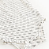 Baby bodystocking with small black dots, long sleeves and buttons at the legs.