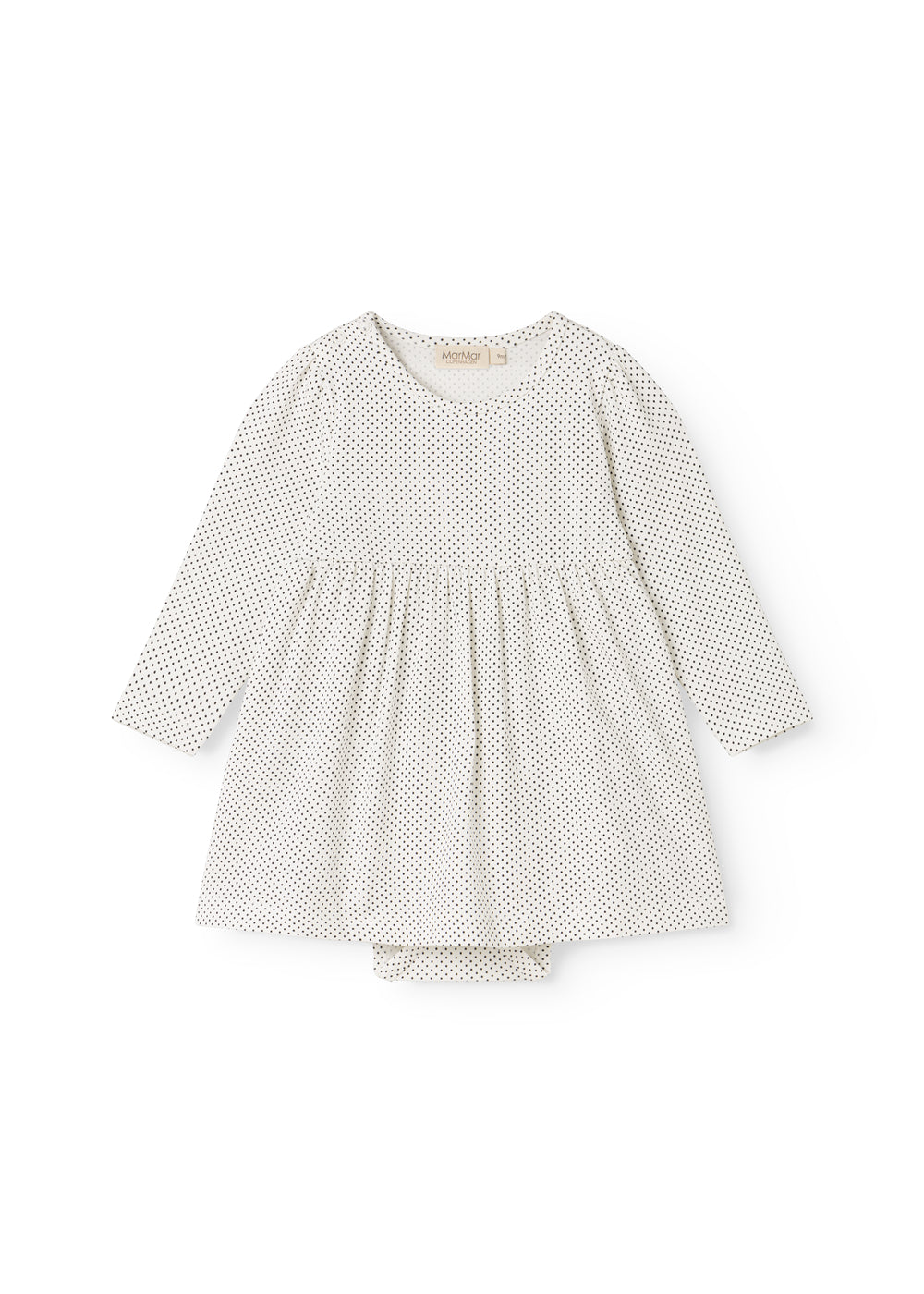 White dress with small black dots, long sleeves and a pleated skirt.