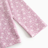 Pink long-sleeve T‑shirt with small white flowers, view from the sleeve and front.