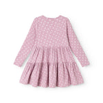 Lilac/pink dress with white flowers, long sleeves and a ruffled hem.