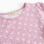 Dress in lilac/pink with small white flowers, round neckline, and brand on the inside.