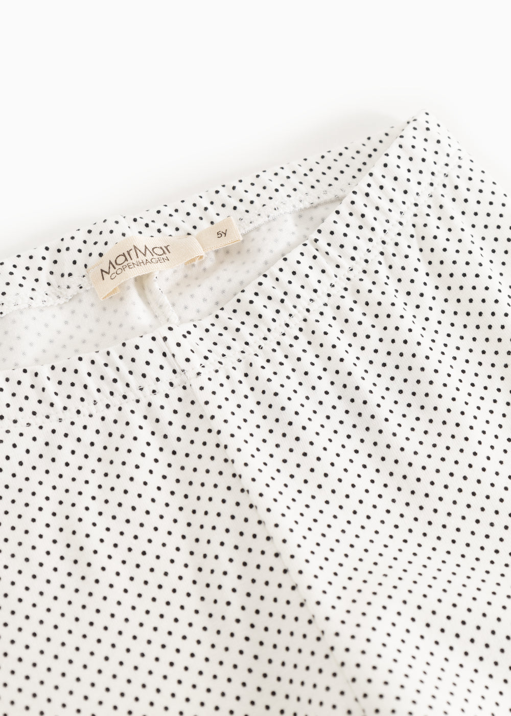 Leggings with MarMar brand at the waist and white, fine polka dot pattern.