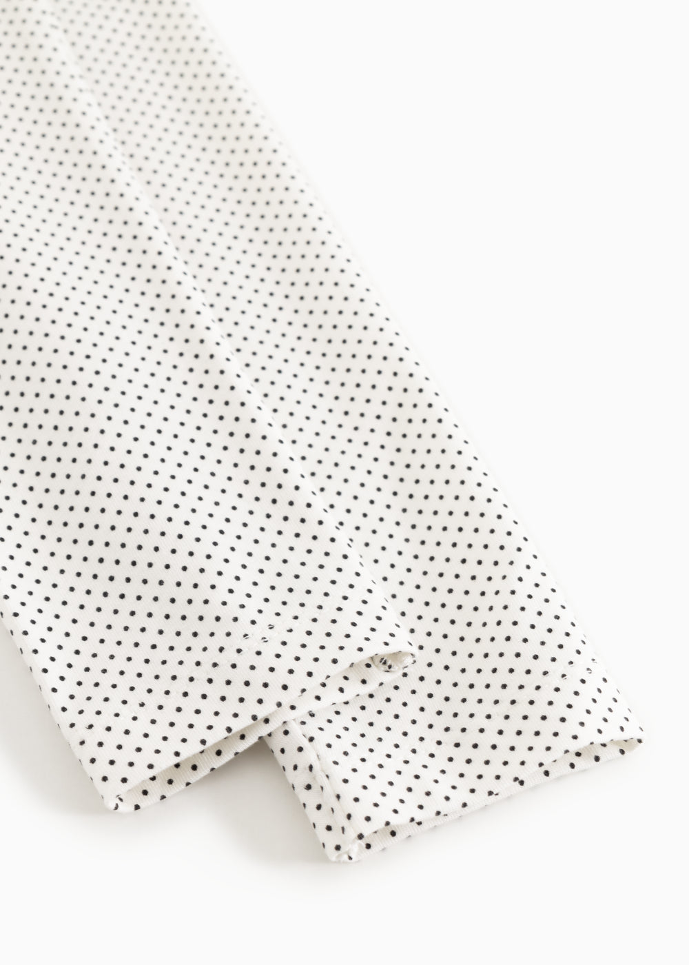 Leggings with elastic edge and fine polka dot pattern, white with black dots.