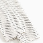 Leggings with elastic edge and fine polka dot pattern, white with black dots.